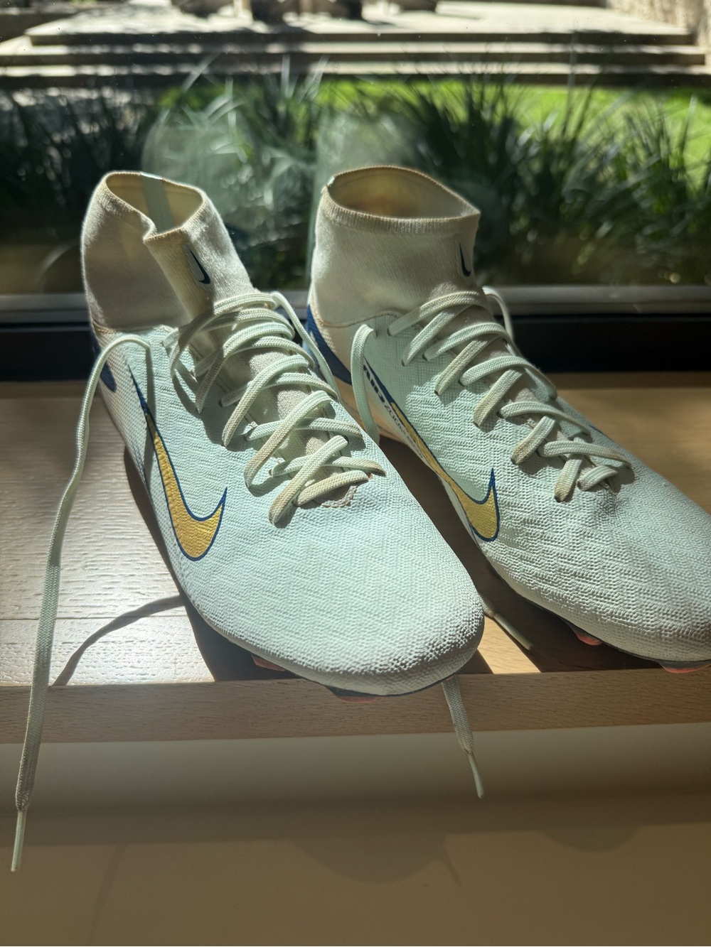 Woman’s Nike CR7 High-Collar Soccer Cleats in Light Aqua with Gold Swoosh